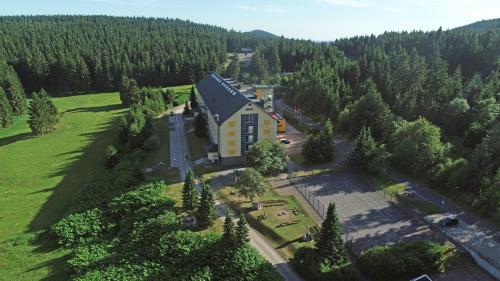 an aerial view of a building in the middle of a forest at A&S Ferienzentrum Oberhof in Oberhof
