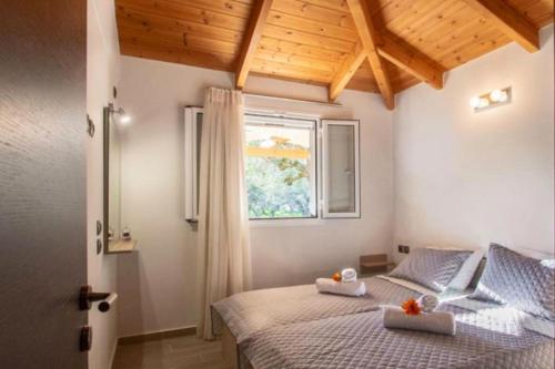 מיטה או מיטות בחדר ב-Deifilia Villa