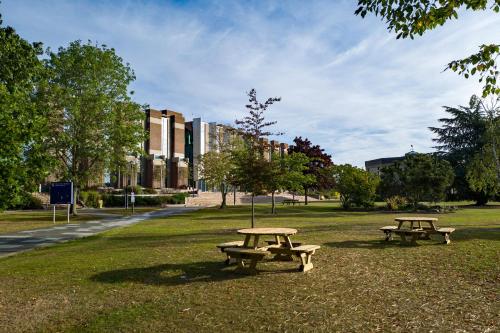 two picnic tables in the grass in a park at Tyler Court, University of Kent in Canterbury