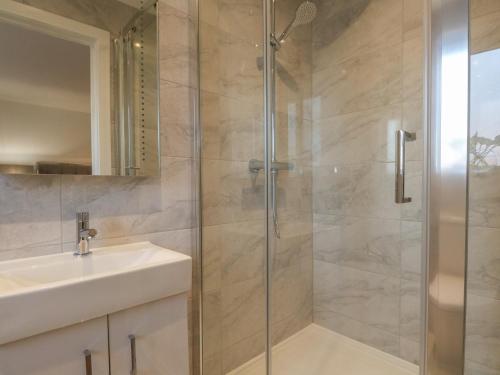 a bathroom with a shower and a sink at Harbourside Haven Apartment 4 in Weymouth
