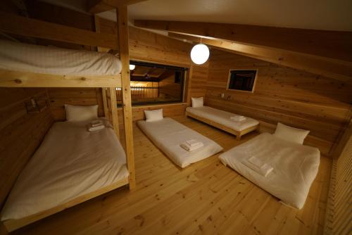 an overhead view of a room with two bunk beds at Tombi Lodge in Iiyama