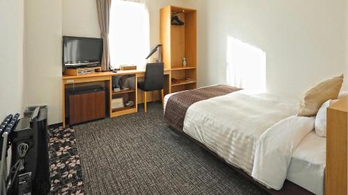 Ένα ή περισσότερα κρεβάτια σε δωμάτιο στο Hotel Annex Inn