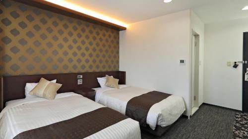 Ένα ή περισσότερα κρεβάτια σε δωμάτιο στο Hotel Annex Inn