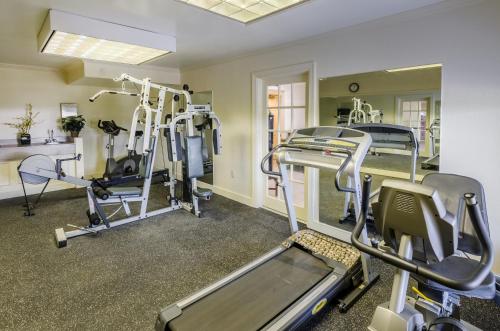 a gym with treadmills and machines in a room at Quality Inn Tanglewood in Roanoke