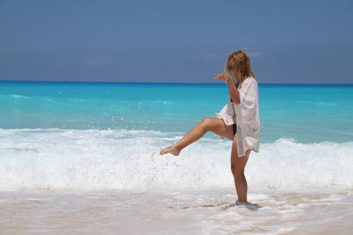 a woman is standing on the beach at Tolip North Coast Hotel in El Alamein