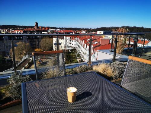 a cup of coffee sitting on a table on a balcony at Margaret apartament in Świnoujście