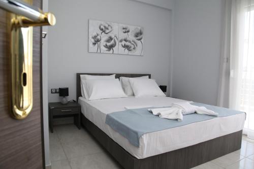 a bedroom with a bed with a blue blanket at Luxury Villa Siniori in Keramoti