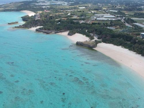 an aerial view of a beach in the ocean at Kaeruya in Nakijin