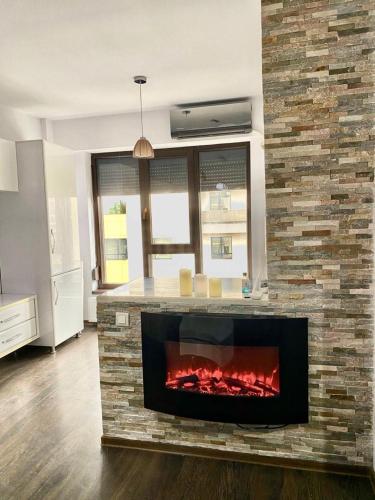 a fireplace in a kitchen with a brick wall at Copou Residence in Iaşi