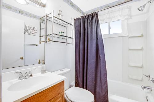 a bathroom with a sink and a toilet and a shower at 37534 Lighthouse Rd #202 in Fenwick Island