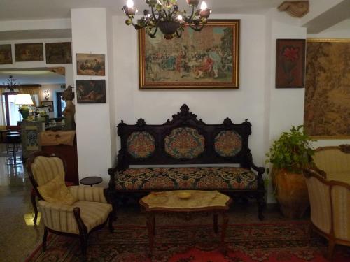 a living room with a couch and a table at Hotel La Riva in Giardini Naxos