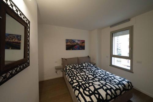 a bedroom with a bed and a mirror on the wall at Amazing BRAND NEW 2 room upper scale with condo GYM close to metro in Milan