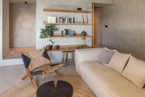 a living room with a couch and a table at CASA DA ILHA - Slow Living Residence & Suites in Ponta Delgada