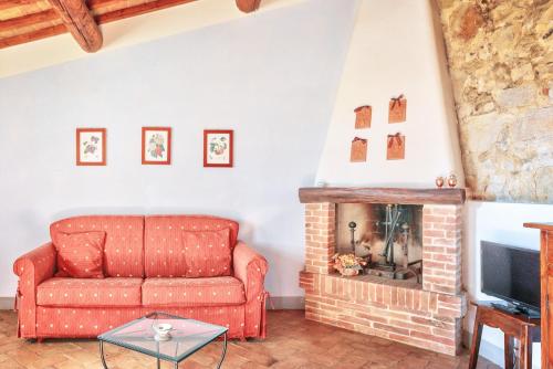 a living room with a couch and a fireplace at Hotel Borgo Casabianca in Serre di Rapolano