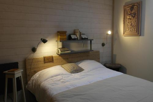 a bedroom with a bed and a shelf on the wall at Gîte, Vintage Touch in Hannonville-sous-les-Côtes