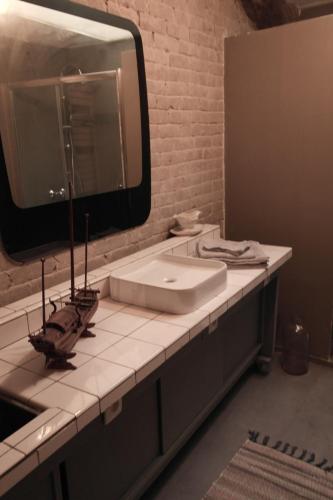 a bathroom with a sink and a large mirror at Gîte, Vintage Touch in Hannonville-sous-les-Côtes