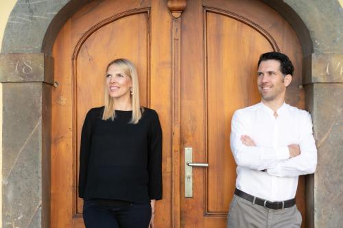 a man and a woman standing in front of a door at Stadthotel zur goldenen Krone in Weiz