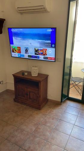 a flat screen tv on the wall of a room at Casa Cardi in Sperlonga