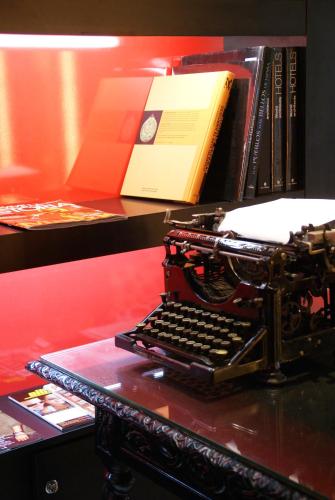 an old typewriter sitting on a table with a book at Hotel Sitges in Sitges