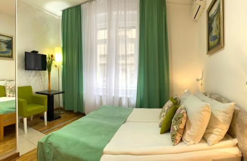 a bedroom with a bed with green curtains and a window at Villa Forever in Belgrade