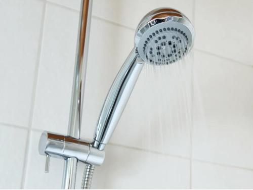 a shower with a shower head in a bathroom at HOTEL GARDEN VILLA in Patna