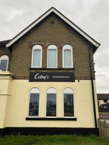 a building with a sign on the side of it at Redwings Lodge Baldock in Baldock