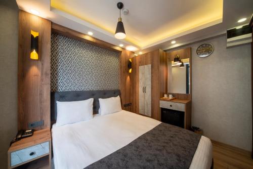 a bedroom with a large white bed in a room at World Heritage Center Hotel in Istanbul