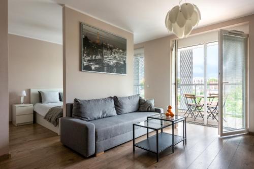 a living room with a couch and a bed at apartamenty-wroc Atal Towers in Wrocław