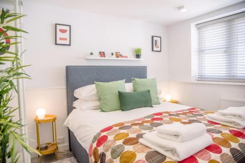 a bedroom with a bed with towels on it at Sutton House, Woodbridge in Woodbridge