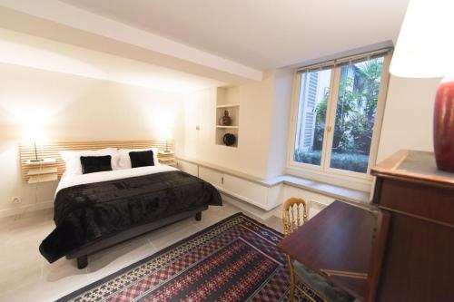une chambre avec un lit, un bureau et une fenêtre dans l'établissement Up & Down, à Paris