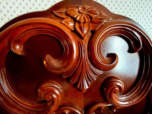 a close up of a wooden object with designs on it at Celebrity Boutique Hotel in Deadwood
