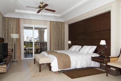 a bedroom with a large bed and a balcony at Hotel Riu Palace Tikida Agadir - All Inclusive in Agadir