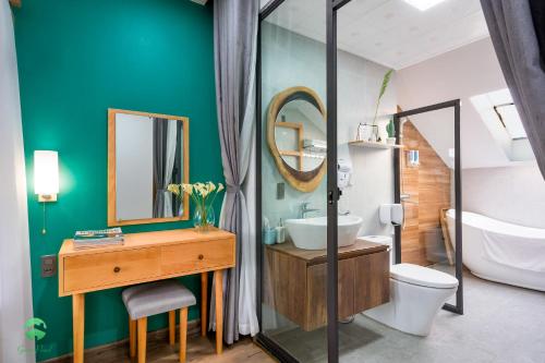 a bathroom with a sink toilet and a mirror at Green Pearl Villa Ha Long in Ha Long