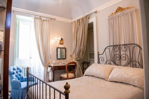 a bedroom with a bed and a chair and a desk at Casa Isabella B&B in Rocca San Giovanni