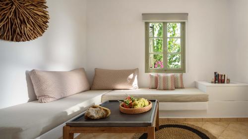 a living room with a couch and a table at Mirabeli Apartments & Suites in Pollonia