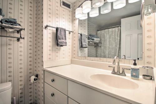 a bathroom with a sink and a mirror at Beachfront Ocean City Condo with 2 Balconies and Views in Ocean City