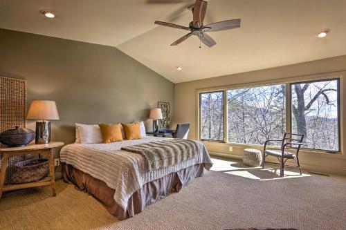 een slaapkamer met een bed en een plafondventilator bij Luxe Rumbling Bald Retreat with Deck and Mountain View in Lake Lure