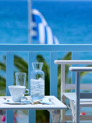 a table with a bottle of water and a cup at Blue Harmony Hotel in Kinion