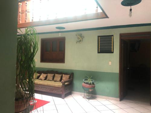 a living room with a couch in the corner of a room at San Pablo in Pátzcuaro