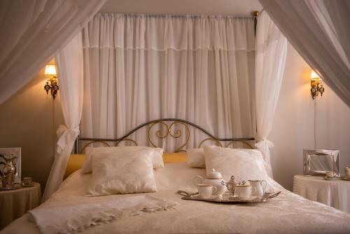 a bedroom with a bed with a tray of tea cups at Casa Isabella B&B in Rocca San Giovanni