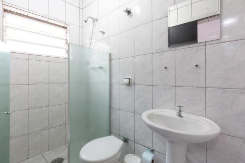 a white bathroom with a sink and a toilet at Hotel Anália Franco in Sao Paulo