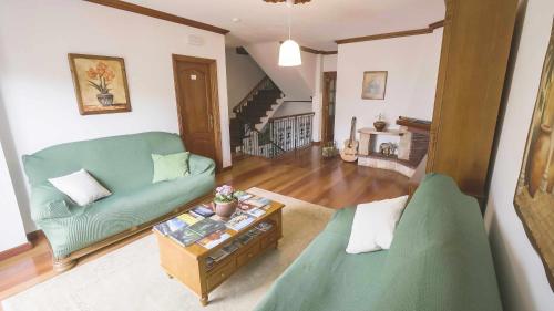 a living room with a green couch and a table at Canary Bio Hostel Tenerife in Los Realejos