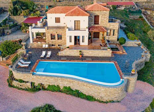 an aerial view of a house with a swimming pool at Villa Selini in Kouroúpi