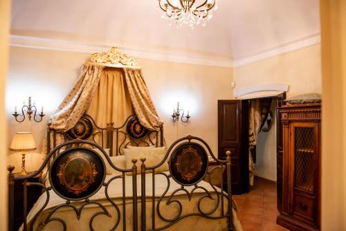 a bedroom with a bed and a chandelier at Casa Isabella B&B in Rocca San Giovanni