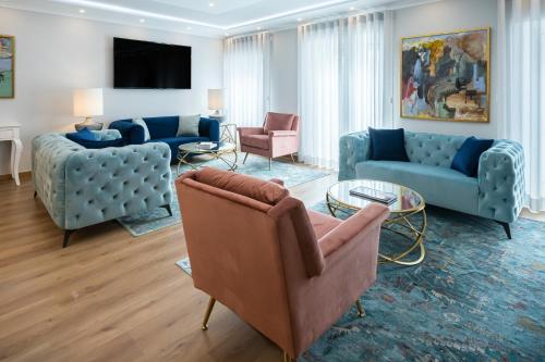 a living room with blue couches and a table at Comtesse Lisbonne Guest House by Homing in Lisbon