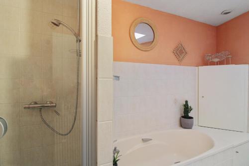 a bathroom with a shower and a tub and a sink at Maison confortable Ornans + Jardin in Ornans