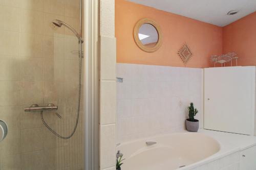 a bathroom with a shower and a tub and a sink at Maison de 2 chambres avec terrasse et wifi a Ornans in Ornans