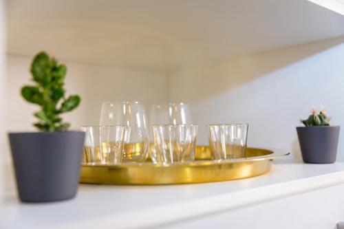 a gold tray with glasses on a shelf with plants at Comtesse Lisbonne Guest House by Homing in Lisbon
