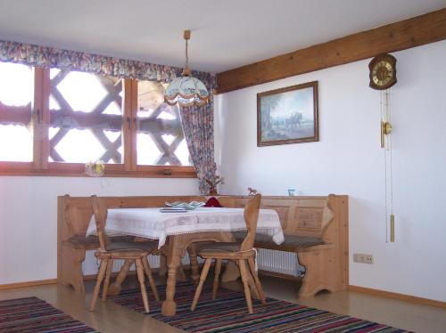 a dining room with a table and two chairs at Bachtelhuber-Hof in Teisendorf