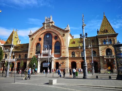 a large building with people walking in front of it at Crowne Plaza Budapest by IHG in Budapest
